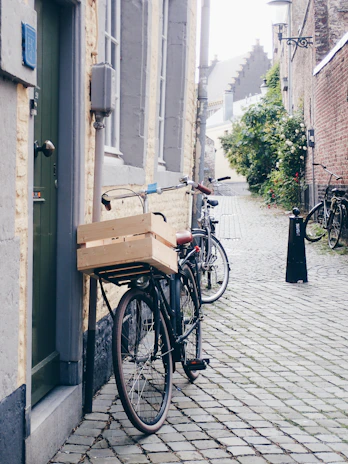A charming street scene with vintage bicycles parked along a cobblestone path.