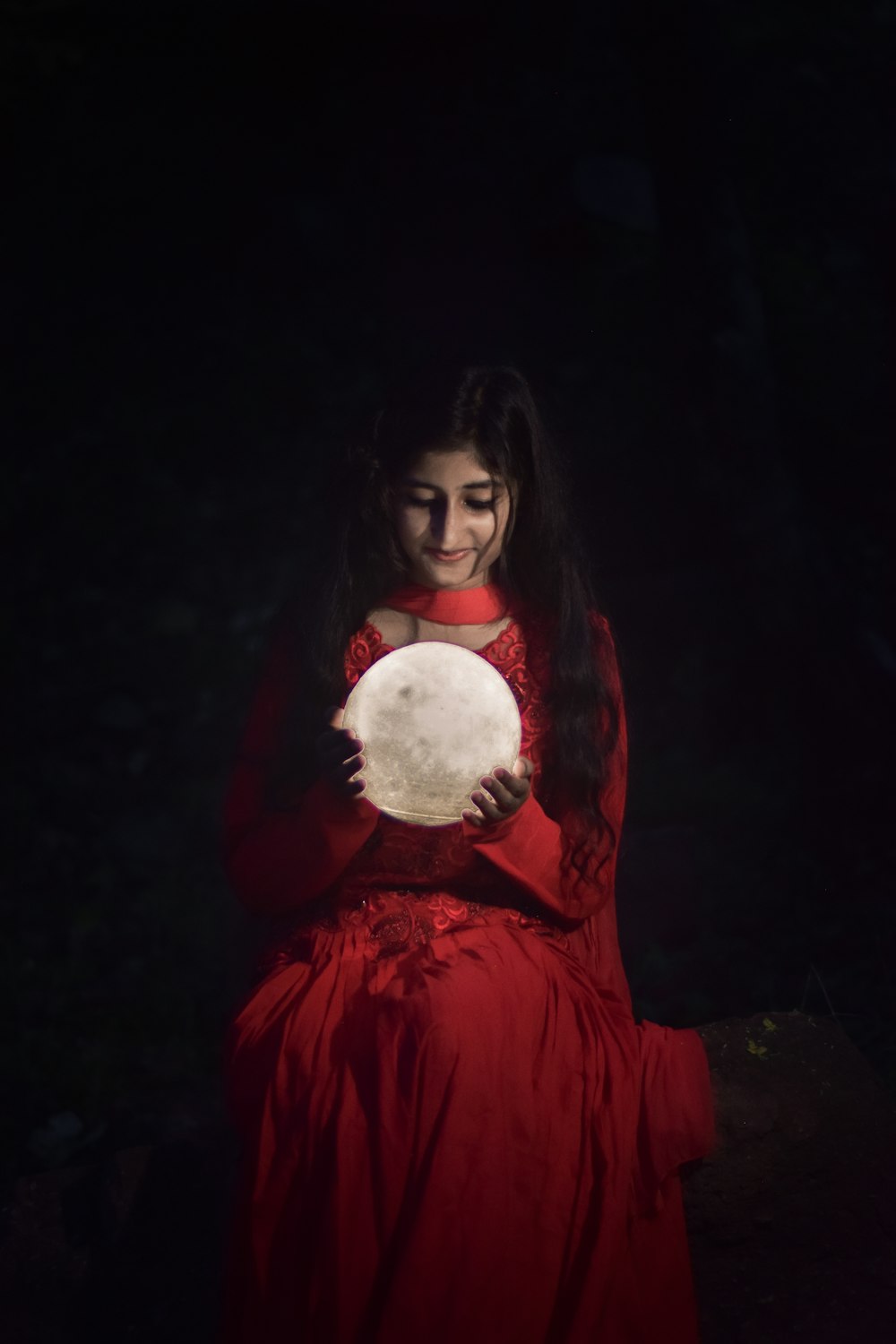 woman in red dress holding white plush toy