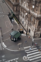 green stand on road near people walking on sidewalk during daytime