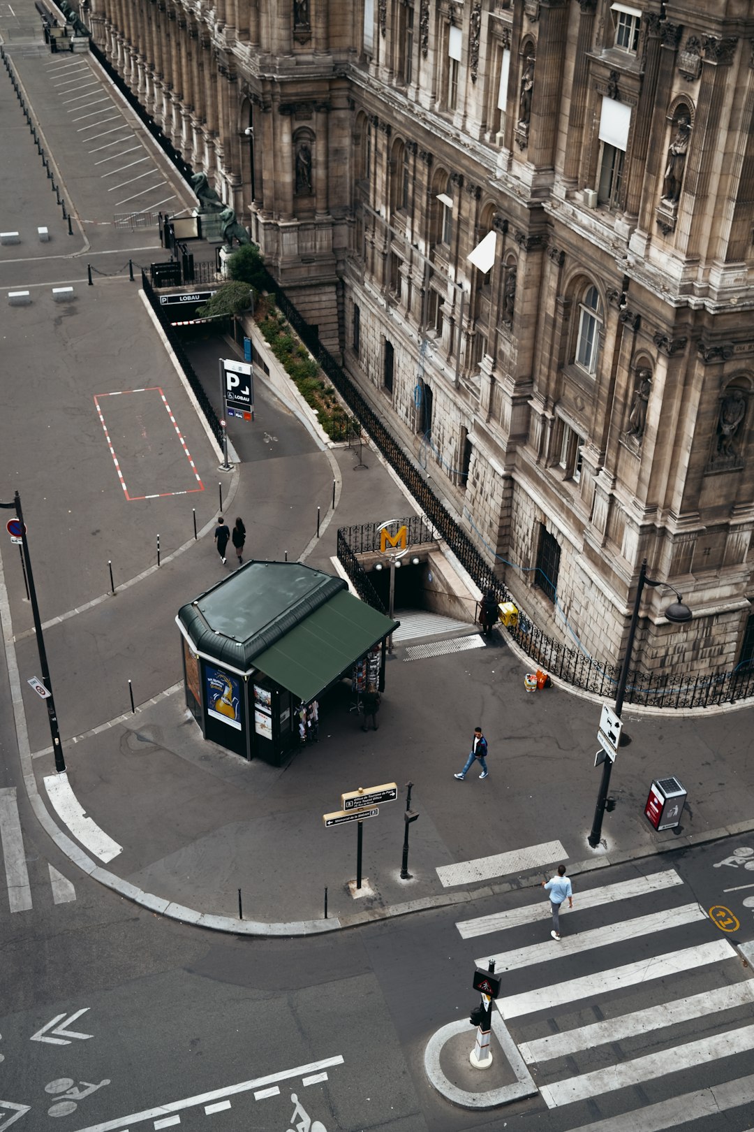 green truck on road near people walking on sidewalk during daytime