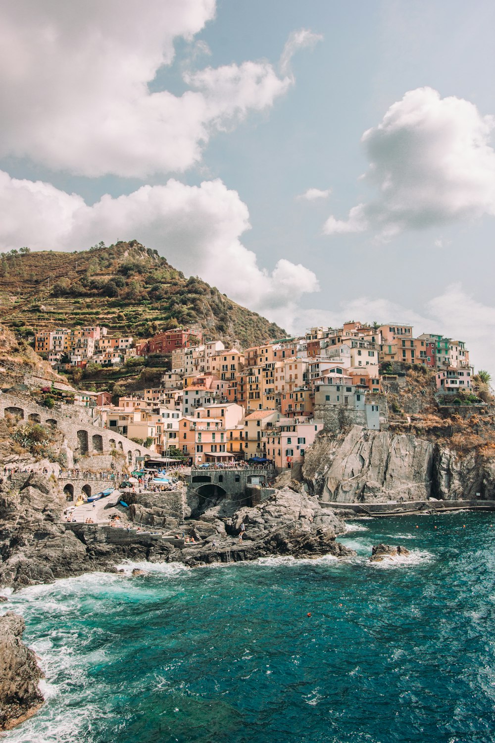 houses near body of water under cloudy sky during daytime