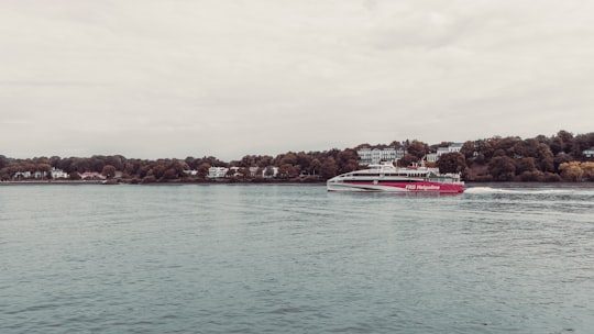 white and red boat on sea during daytime in Teufelsbrück Germany