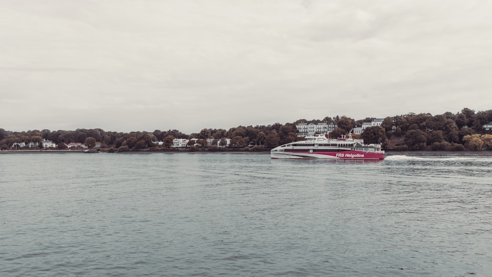 white and red boat on sea during daytime