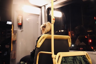 woman in black shirt sitting on yellow chair