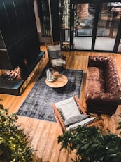 brown leather couch beside brown wooden table