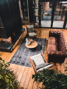 brown leather couch beside brown wooden table