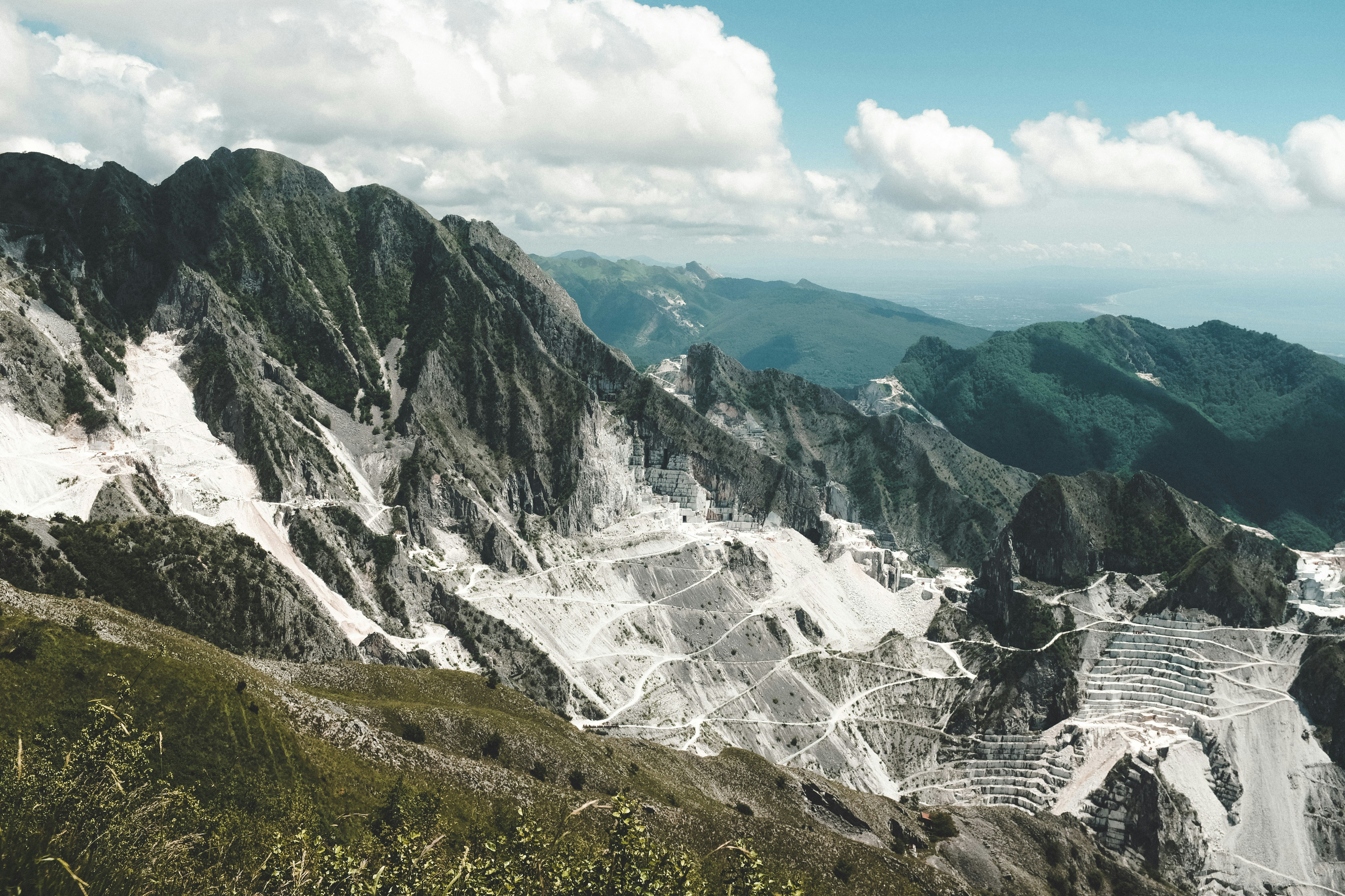 green and brown mountains under white clouds during daytime, Marble cave