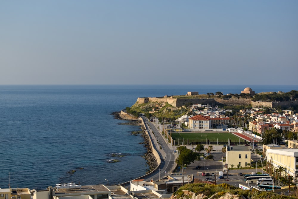 houses near sea under blue sky during daytime