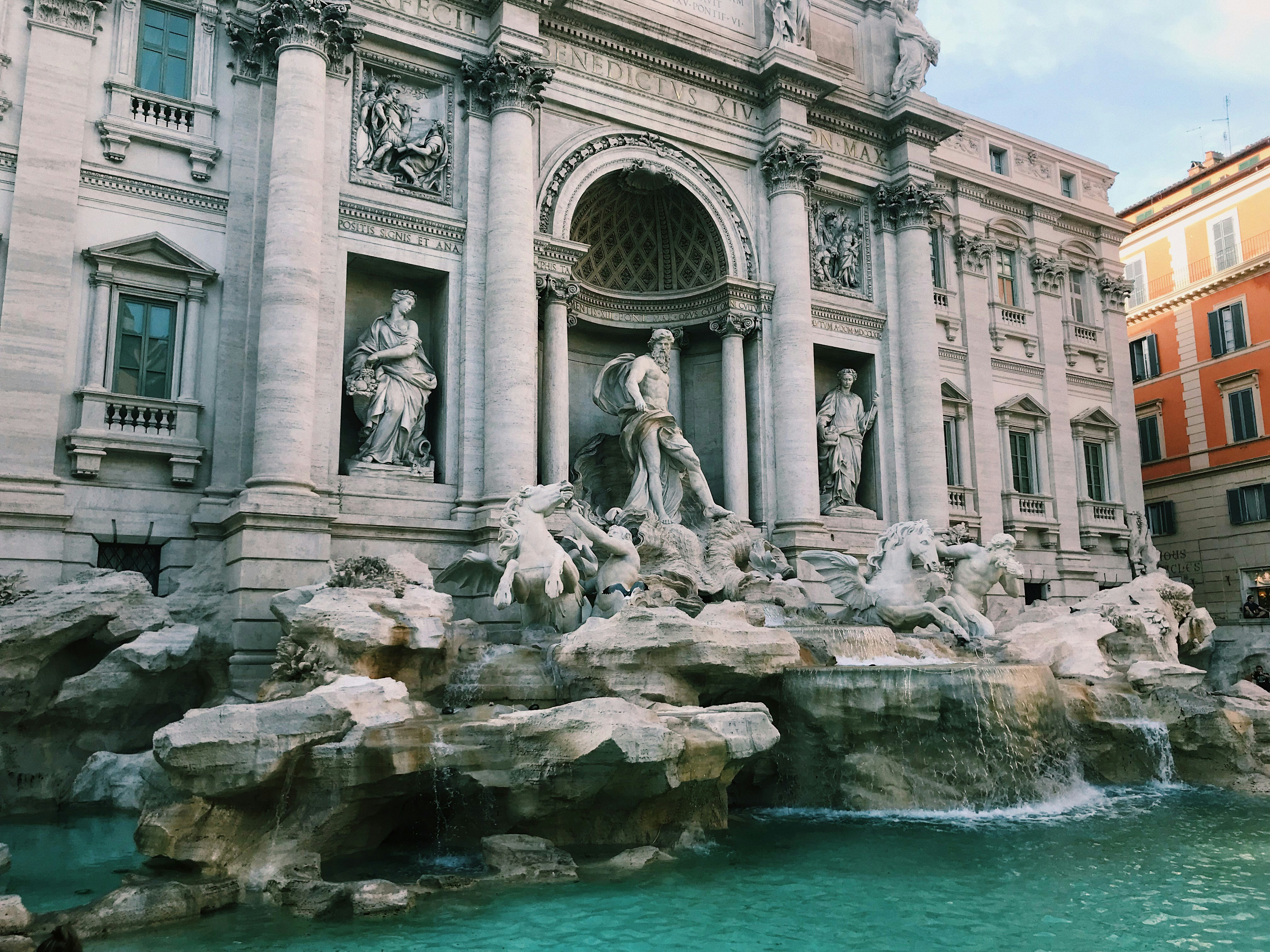 gray concrete building near body of water during daytime, 