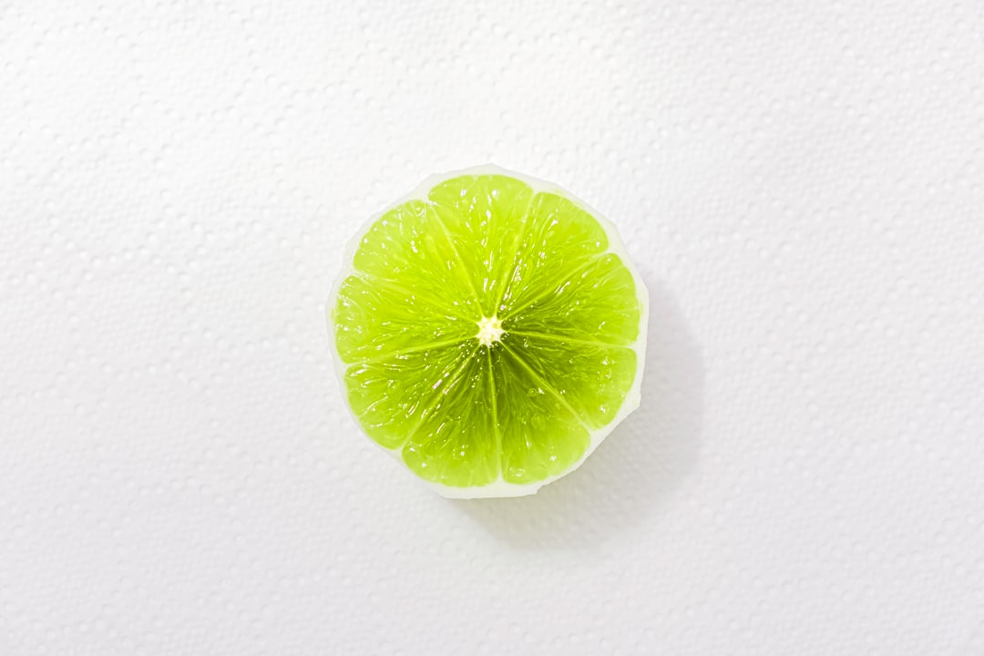 yellow sliced lemon on white surface