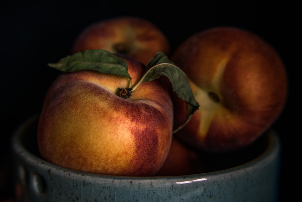 red and green apples in blue ceramic bowl