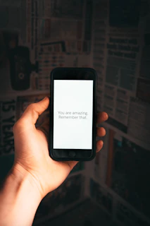 person holding black iphone 4