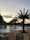 Happy family relaxing together by the villa’s private pool under soft sunset light