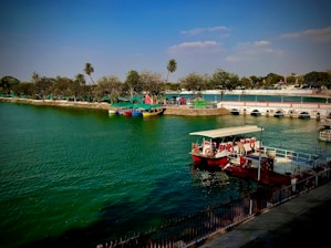 red and white boat on body of water during daytime