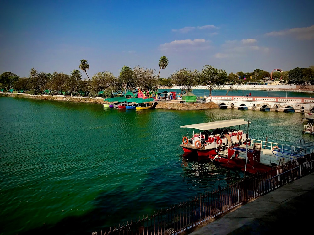 red and white boat on body of water during daytime