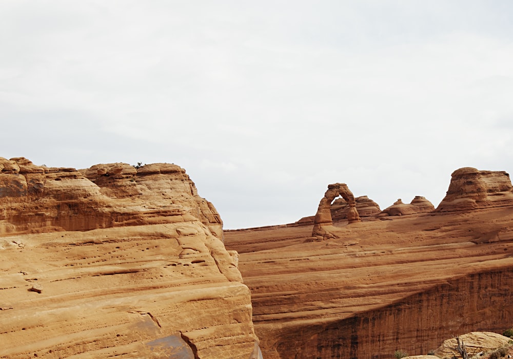 brown rock formation under white sky during daytime