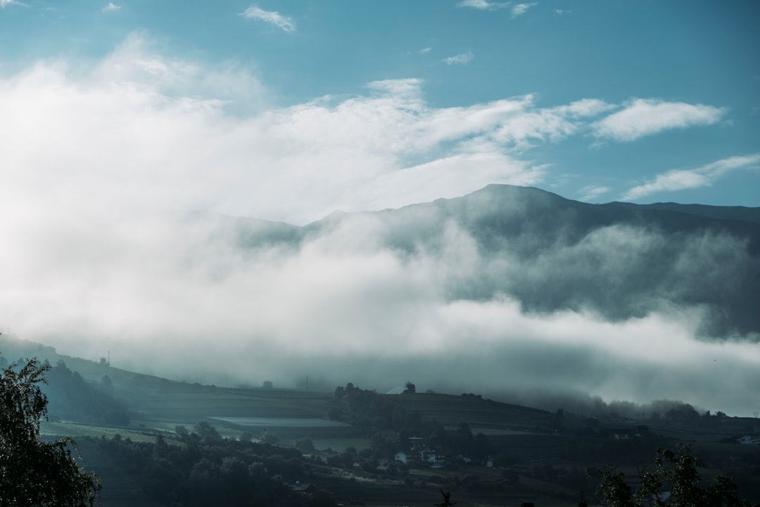 green mountains under white clouds during daytime