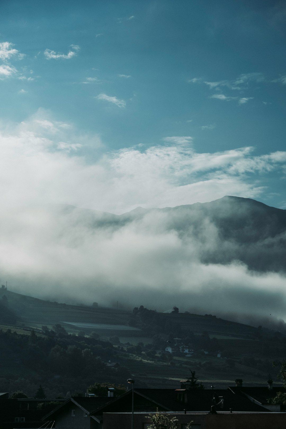 grayscale photo of mountains under cloudy sky