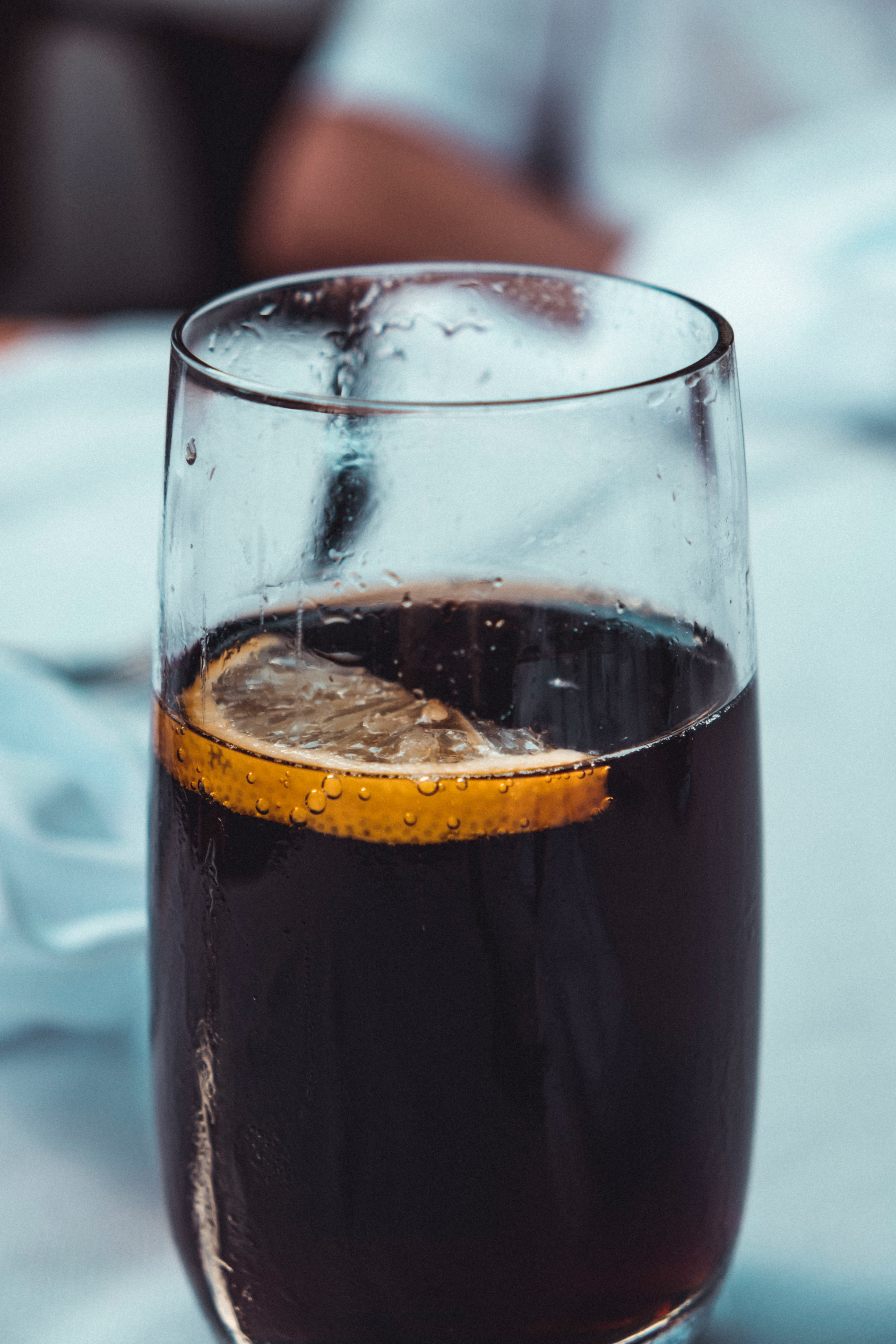 clear drinking glass with black liquid