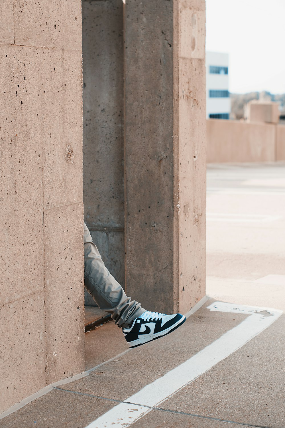 person in gray pants and blue and white nike sneakers