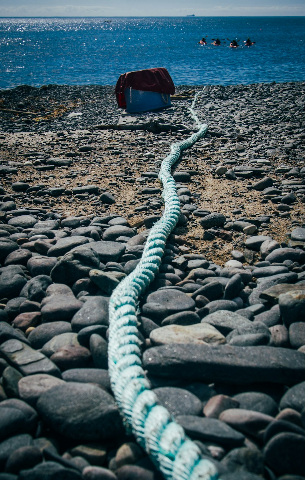 white and blue rope on brown rocky ground
