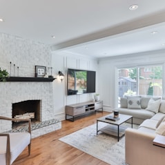 living room with white sofa and black flat screen tv