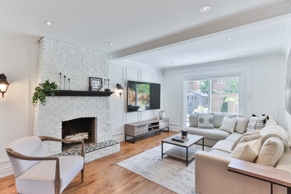 living room with white sofa and black flat screen tv