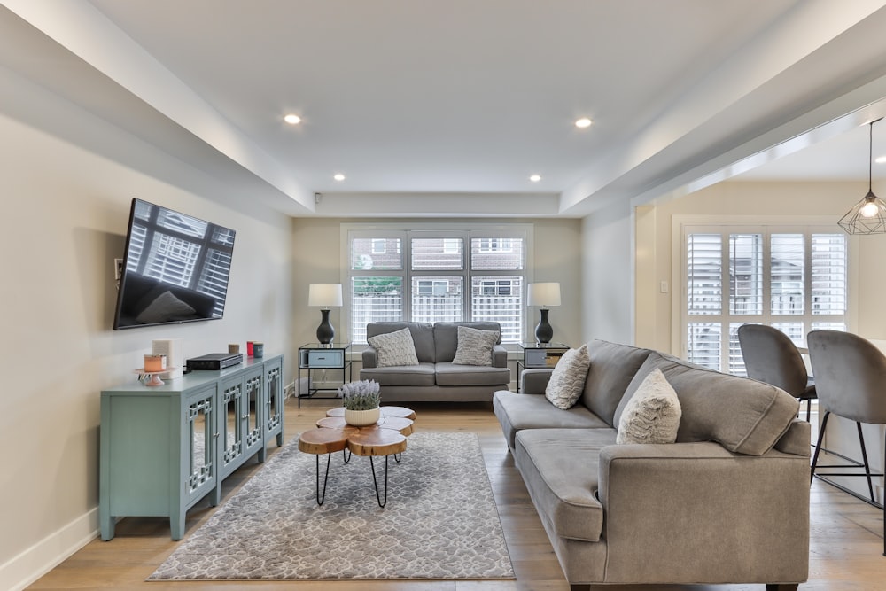 gray couch and white wooden table