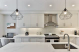 white wooden kitchen cabinet with black pendant lamp