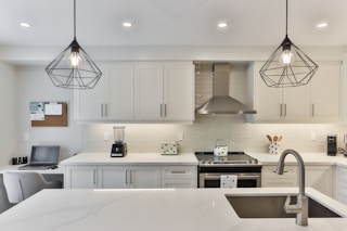 white wooden kitchen cabinet with black pendant lamp
