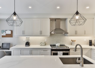 white wooden kitchen cabinet with black pendant lamp