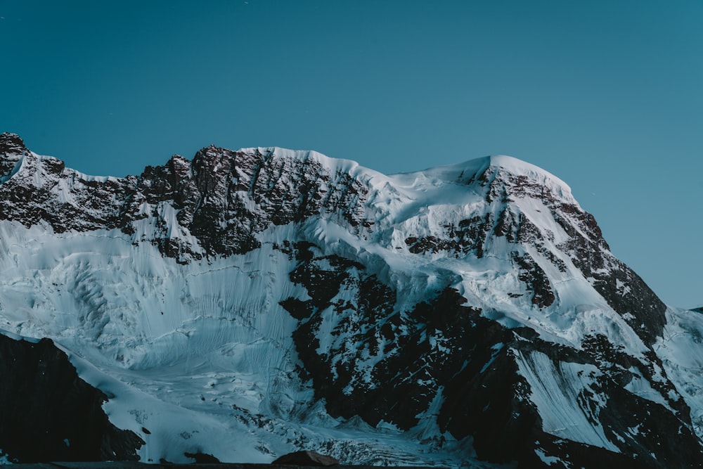 snow covered mountain under blue sky during daytime