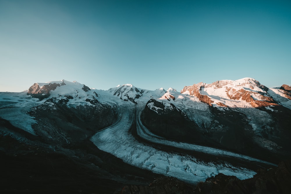 snow covered mountain under blue sky during daytime