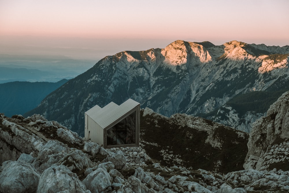 white and black house on rocky mountain during daytime