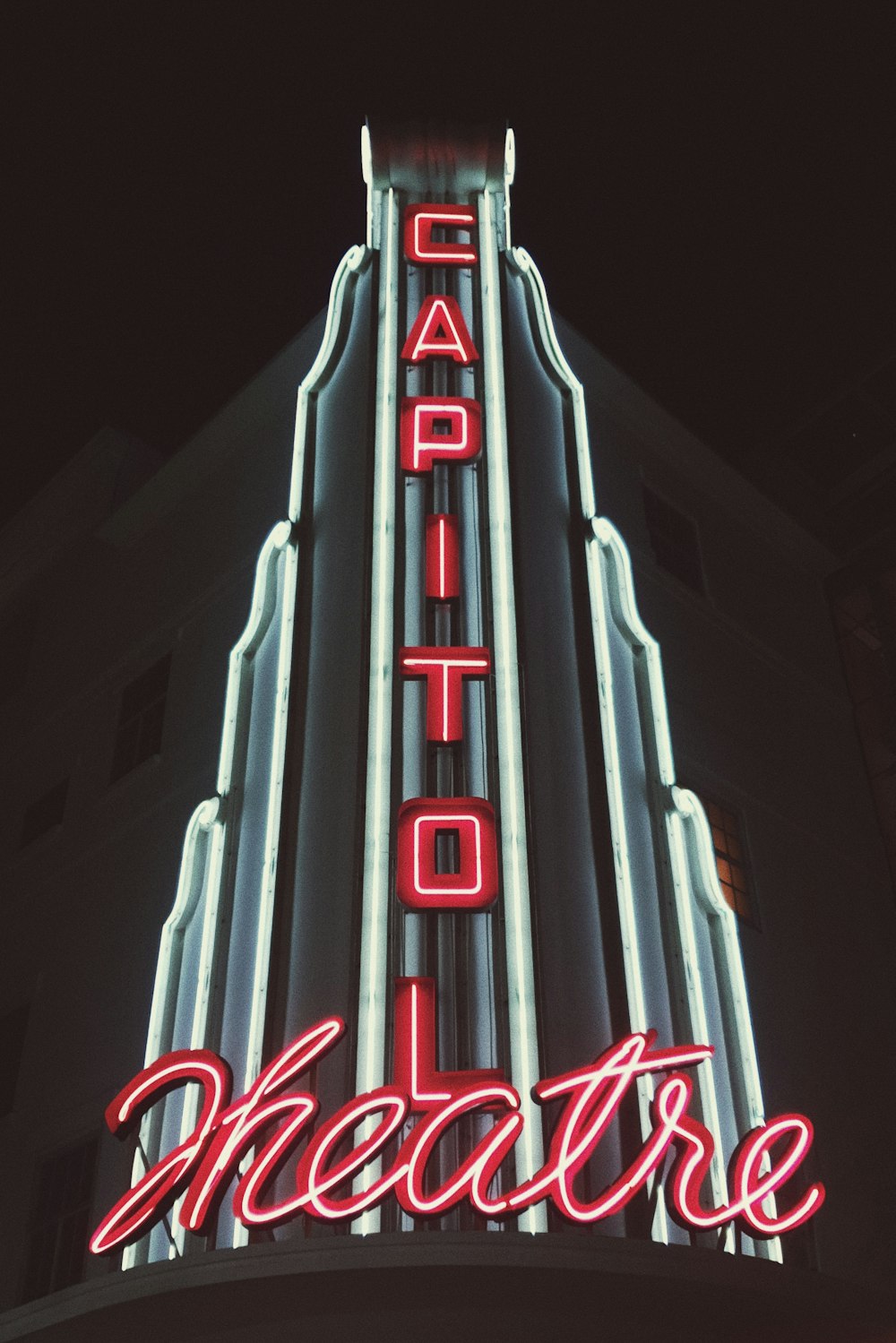 the capitol theatre sign lit up at night
