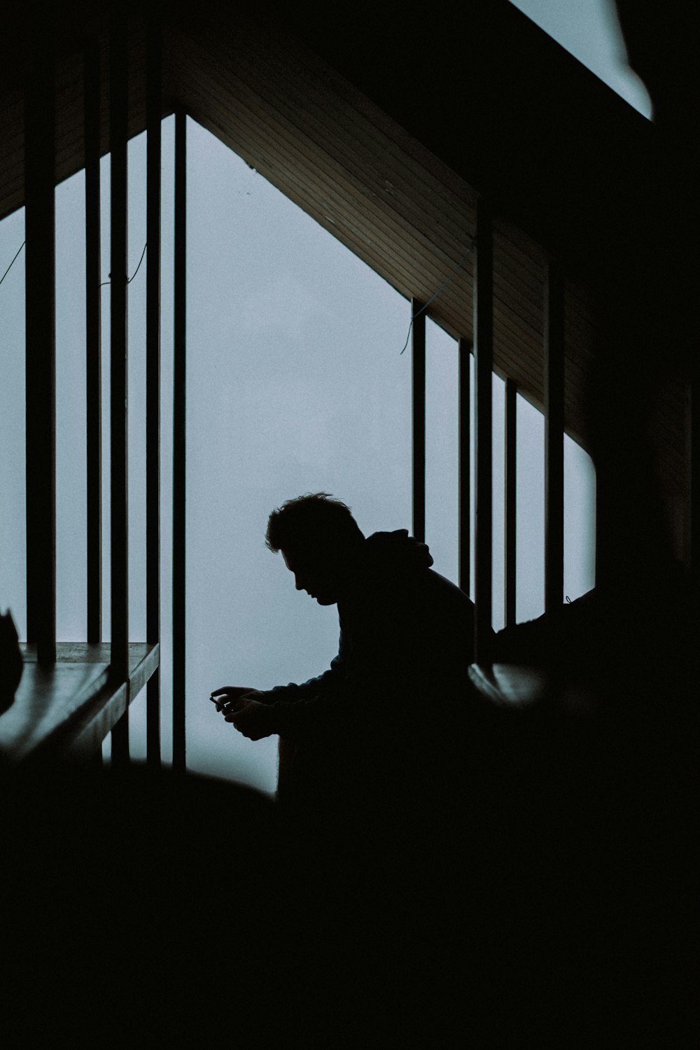 silhouette of man standing near window