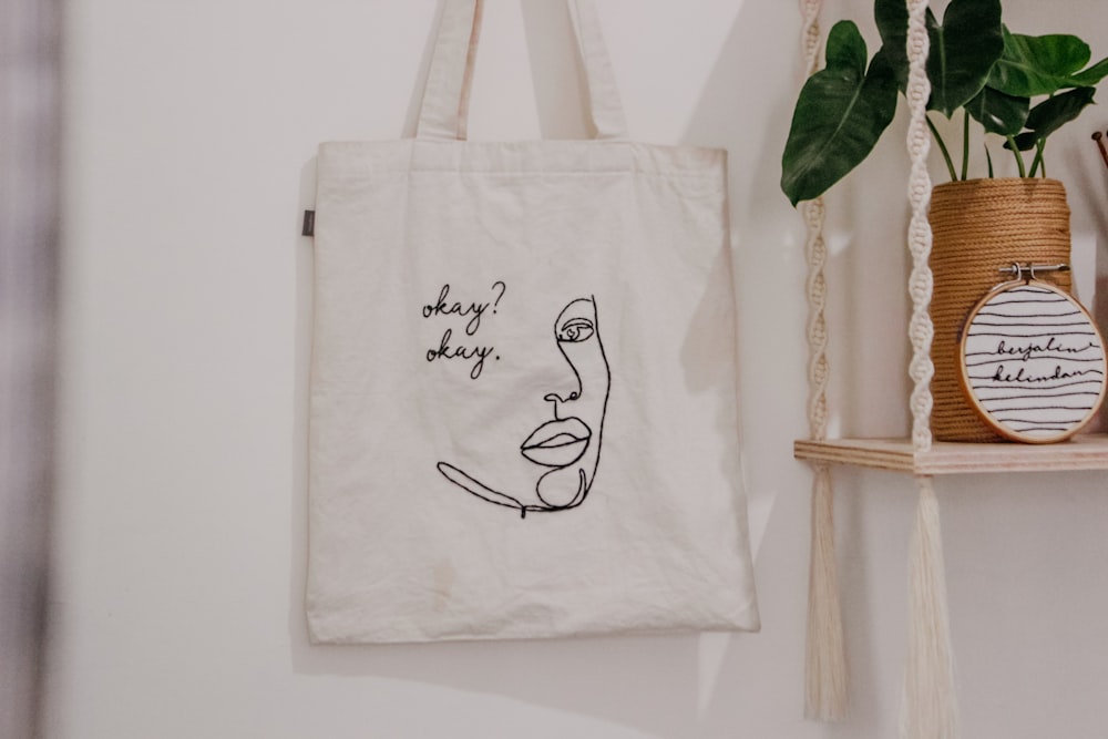 white tote bag on white wall