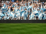 A vibrant sports event with spectators cheering in the stands.