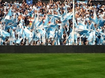 A group of enthusiastic fans cheering at a local Hawaii sports game.