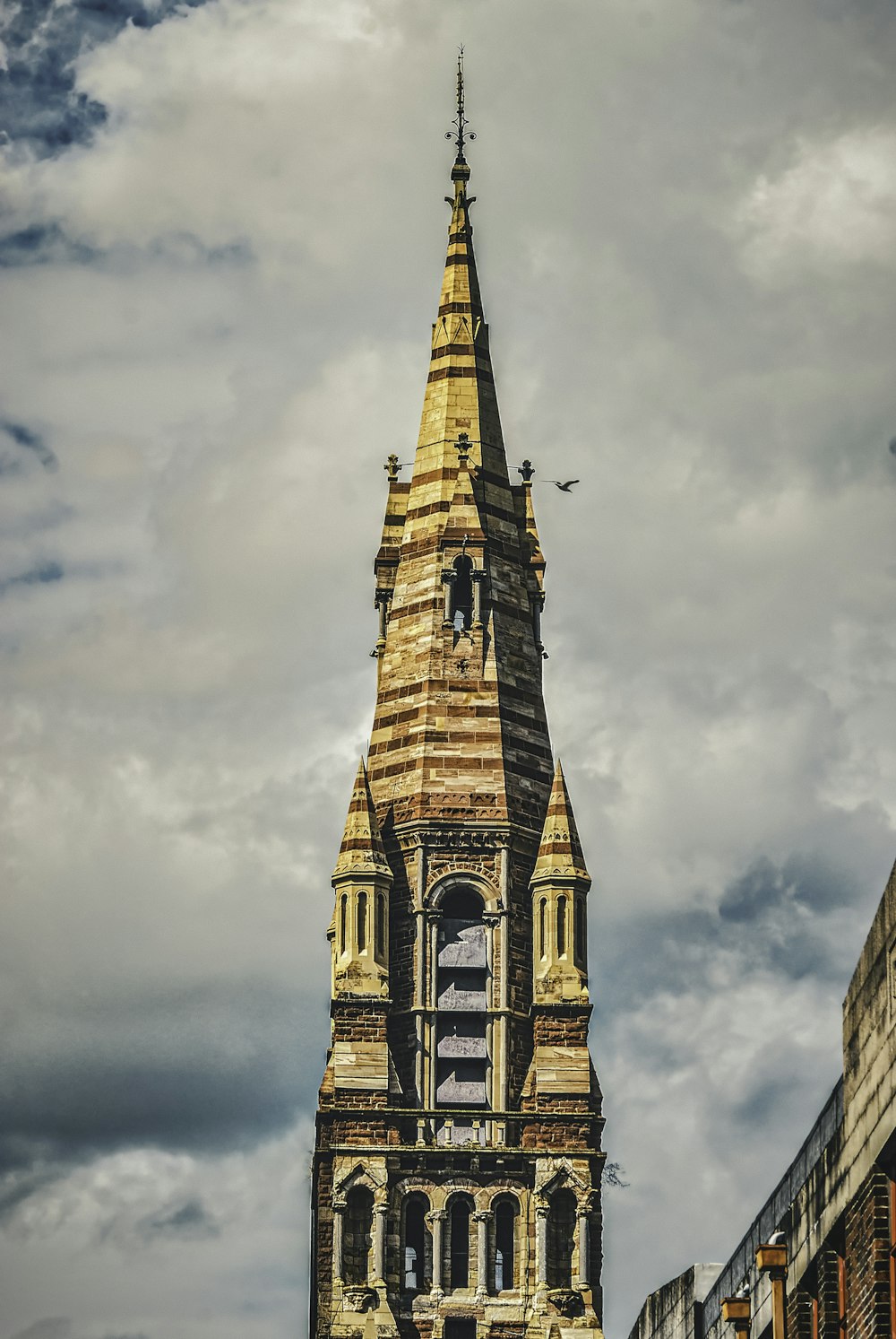 brown concrete building under cloudy sky during daytime