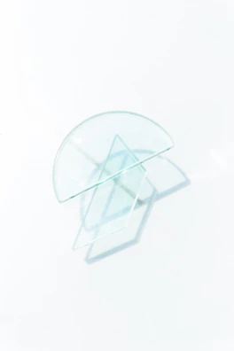 Minimalist cover art featuring sharp geometric shapes with glassmorphism transparency effects.