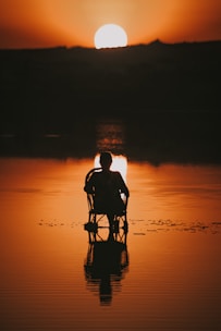silhouette of man on beach during sunset