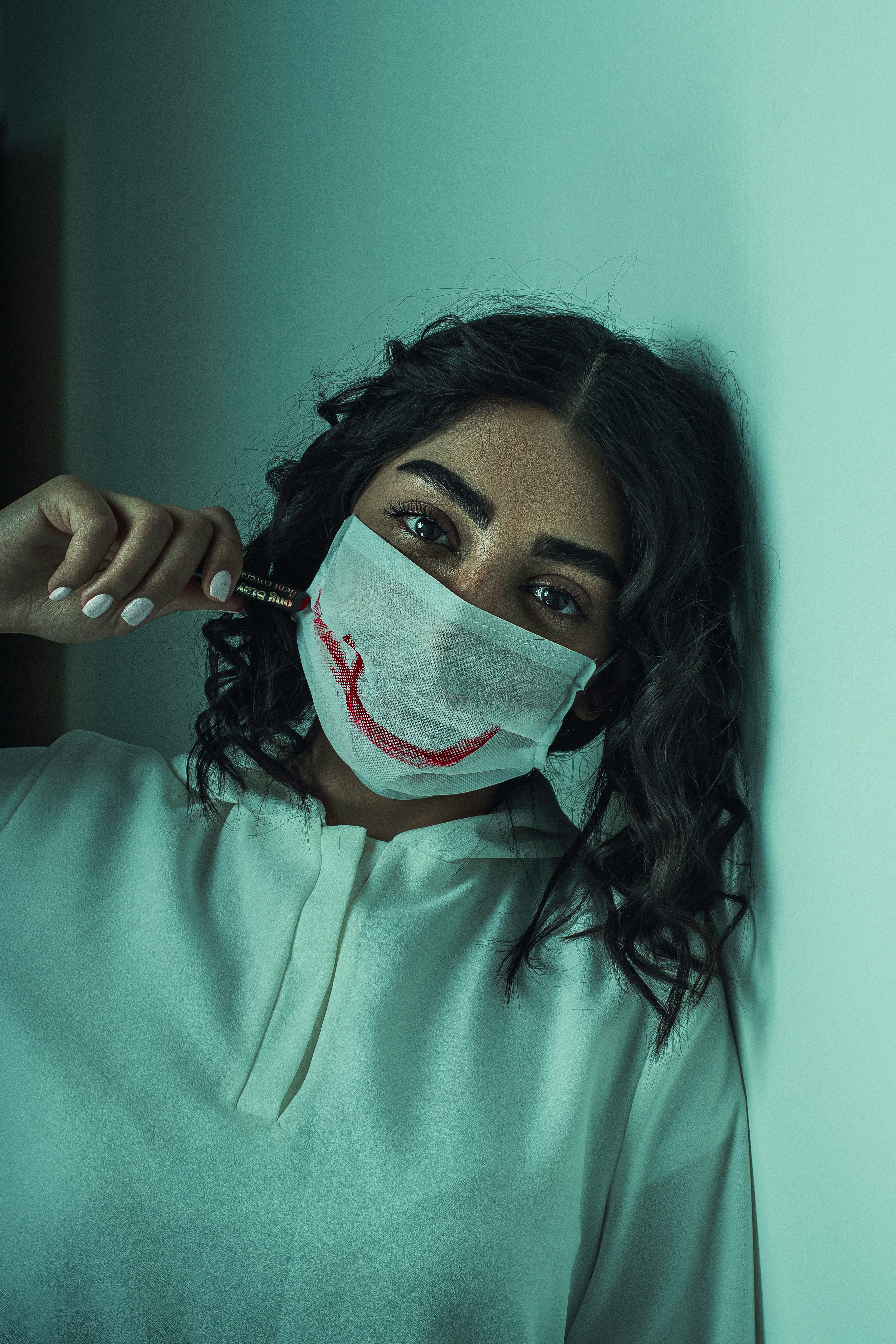 woman in green crew neck shirt with white mask