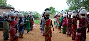 A team of community health workers walking through a neighborhood, carrying medical supplies