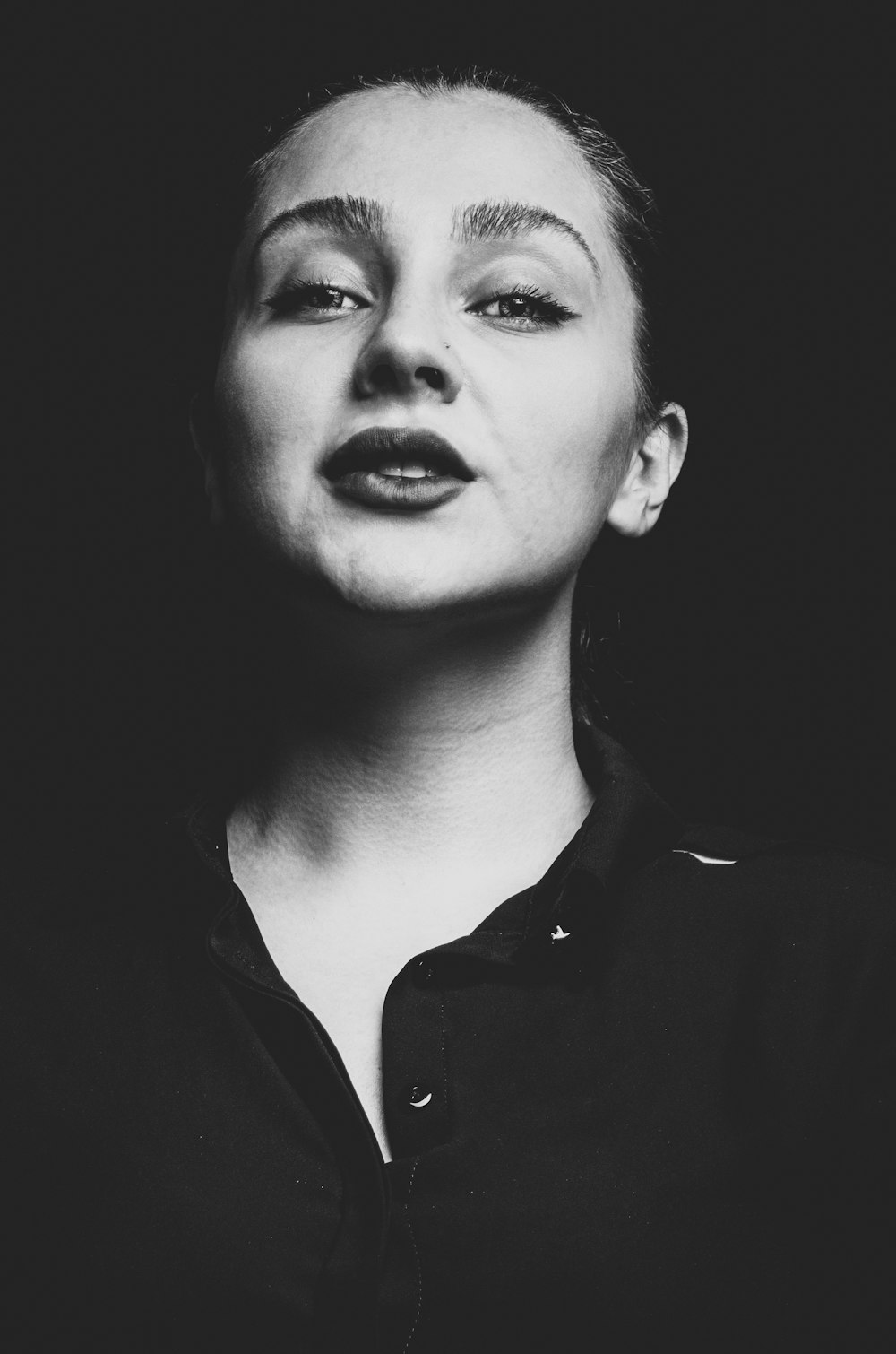 grayscale photo of woman in black collared shirt