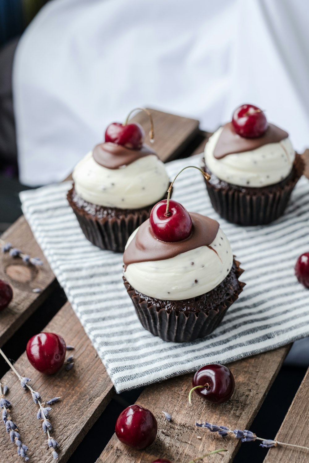 cupcake with white icing on brown wooden table