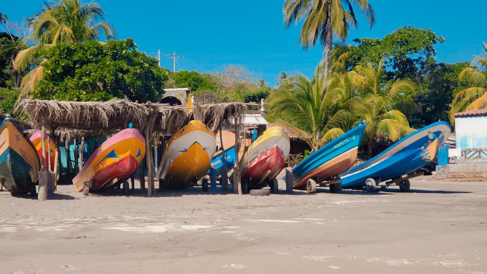 blue and orange boats on beach during daytime
