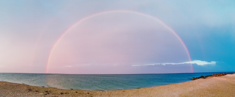 rainbow over the sea during daytime