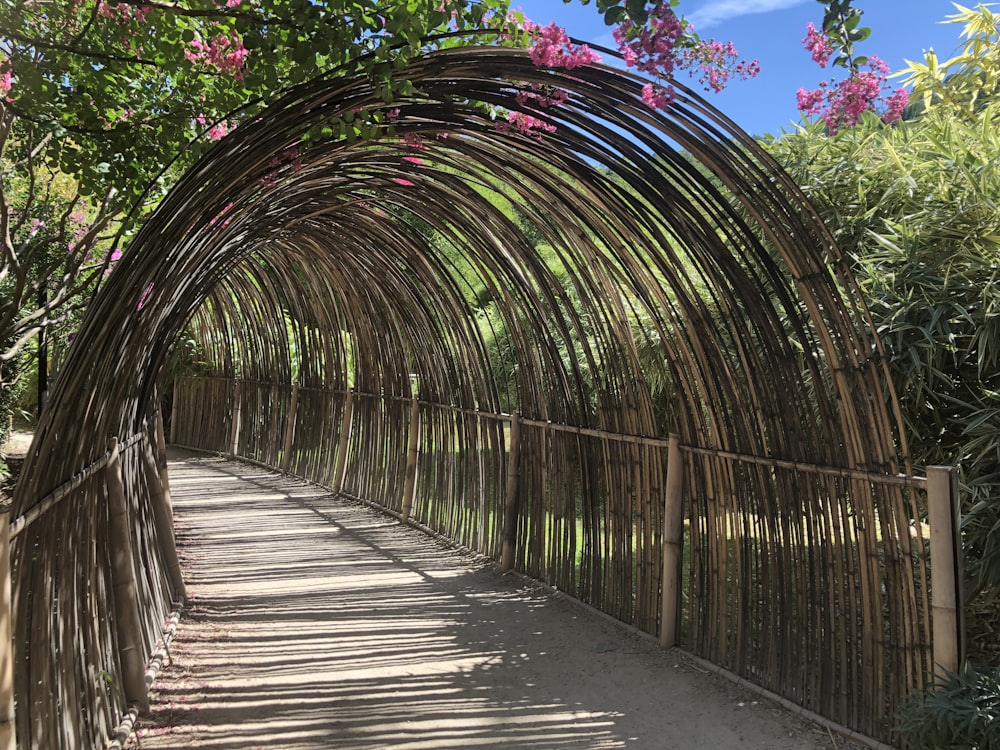 braune Holzbrücke mit grünen Pflanzen