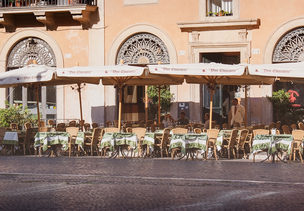 people sitting on chairs near building during daytime